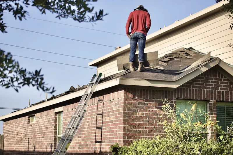 Professional roofer working on a residential roof in Brooks